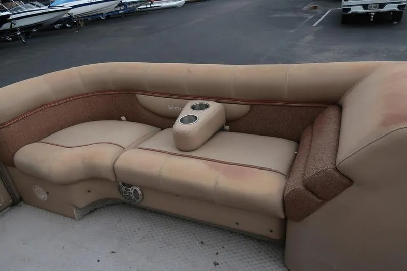 Slide: The Image of 2008 Godfrey SAN PAN 2500 RE boat seating with beige upholstery and cup holders. - 8
