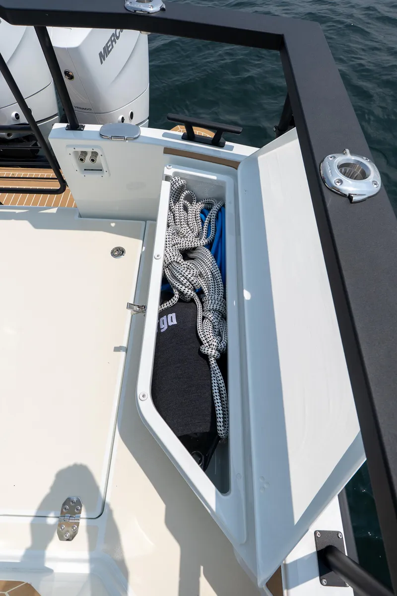 Slide: The Image of 2025 Targa 32 GT boat storage compartment with ropes and gear on deck. - 12