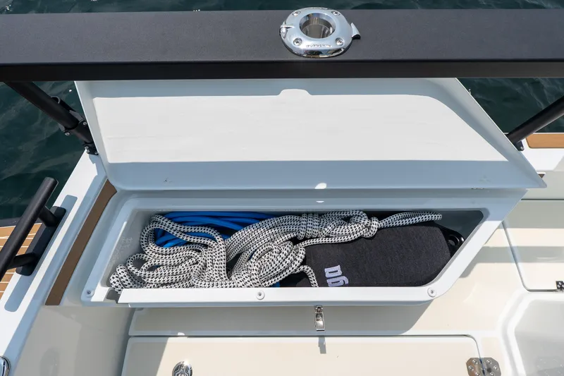 Slide: The Image of Open storage compartment on 2025 Targa 32 GT boat, containing ropes and equipment. - 13