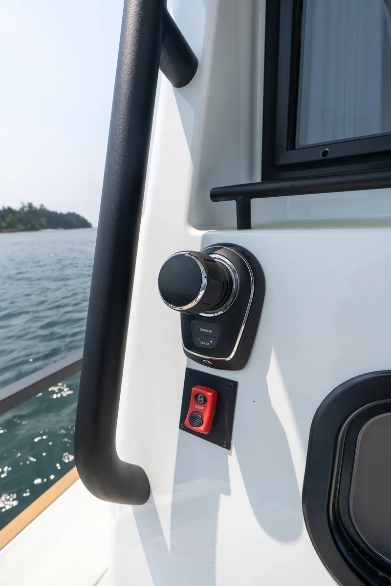 Slide: The Image of Close-up of 2025 Targa 32 GT boat control panel by the water. - 15