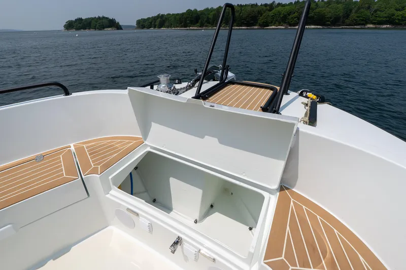 Slide: The Image of 2025 Targa 32 GT boat deck with open storage compartment, featuring sleek design and scenic water view. - 22