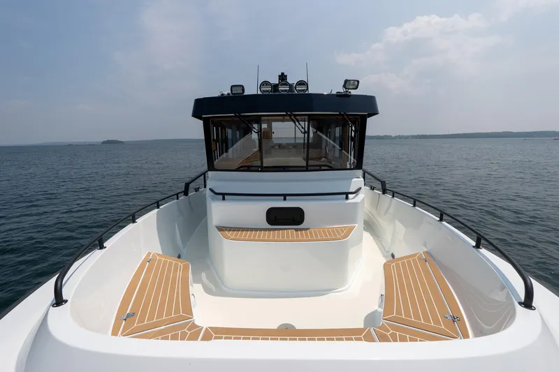 Slide: The Image of 2025 Targa 32 GT boat on open water, featuring sleek design and spacious deck. - 26