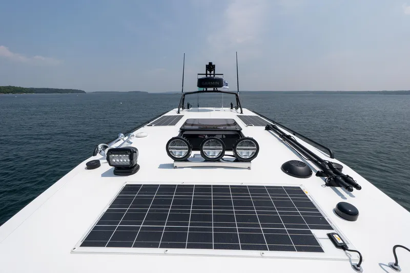 Slide: The Image of 2025 Targa 32 GT boat deck with solar panels and navigational equipment on open water. - 27