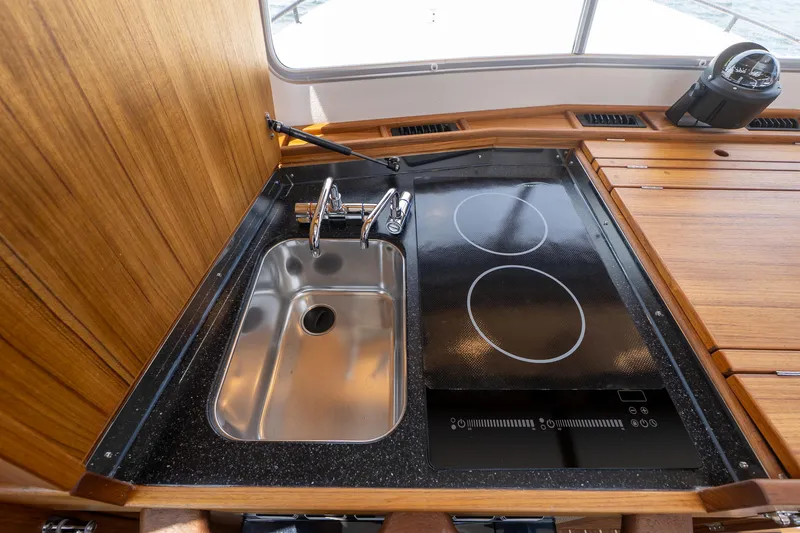 Slide: The Image of Modern kitchen area in 2025 Targa 32 GT boat with sink and stovetop. - 34