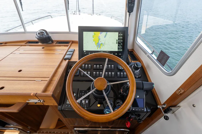 Slide: The Image of Helm of 2025 Targa 32 GT boat with wooden steering wheel and navigation display. - 39