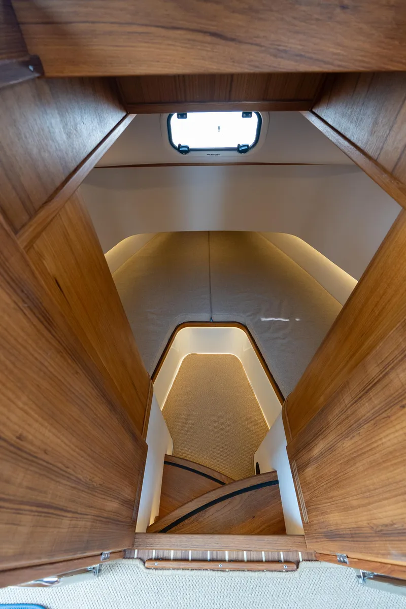 Slide: The Image of Interior view of 2025 Targa 32 GT boat with wooden finish and modern lighting. - 40