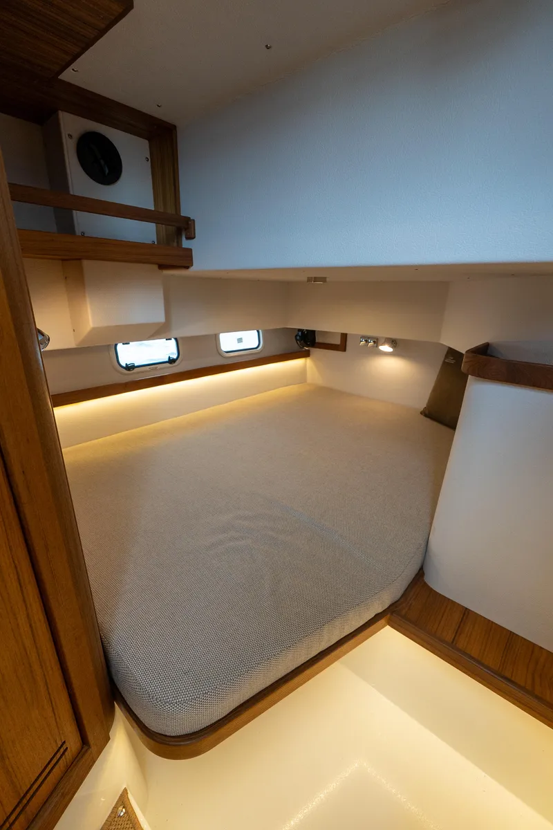 Slide: The Image of 2025 Targa 32 GT cabin interior with cozy bed and ambient lighting. - 44