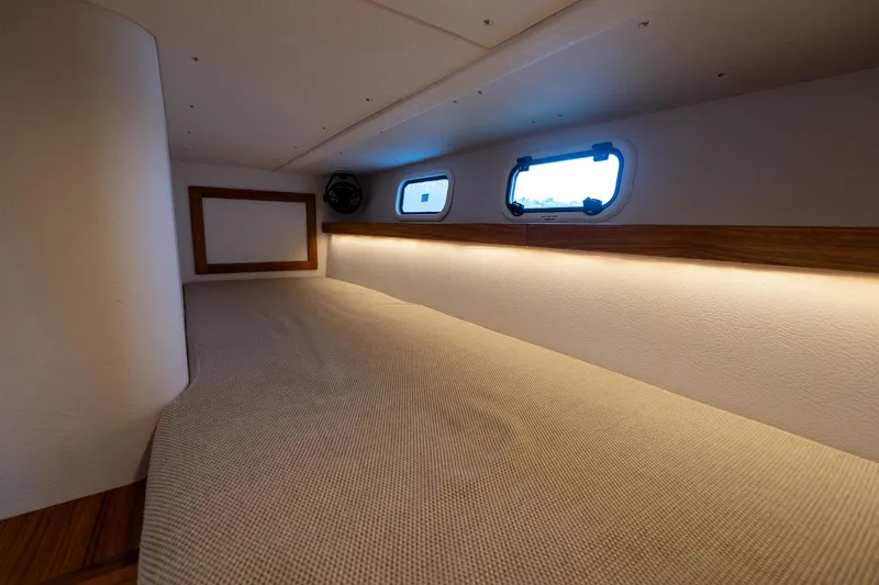 Slide: The Image of Interior cabin of 2025 Targa 32 GT boat with cozy bedding and porthole windows. - 46