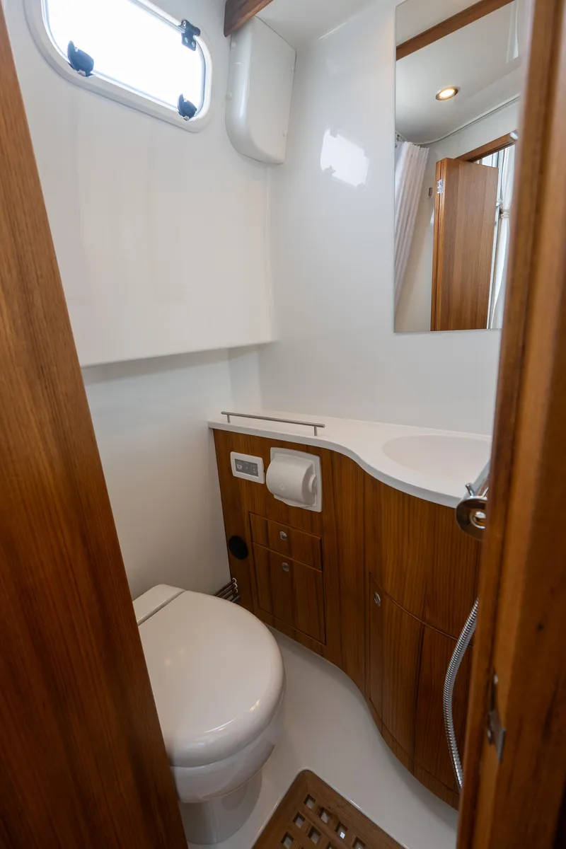 Slide: The Image of 2025 Targa 32 GT yacht bathroom with wooden cabinetry and modern fixtures. - 48