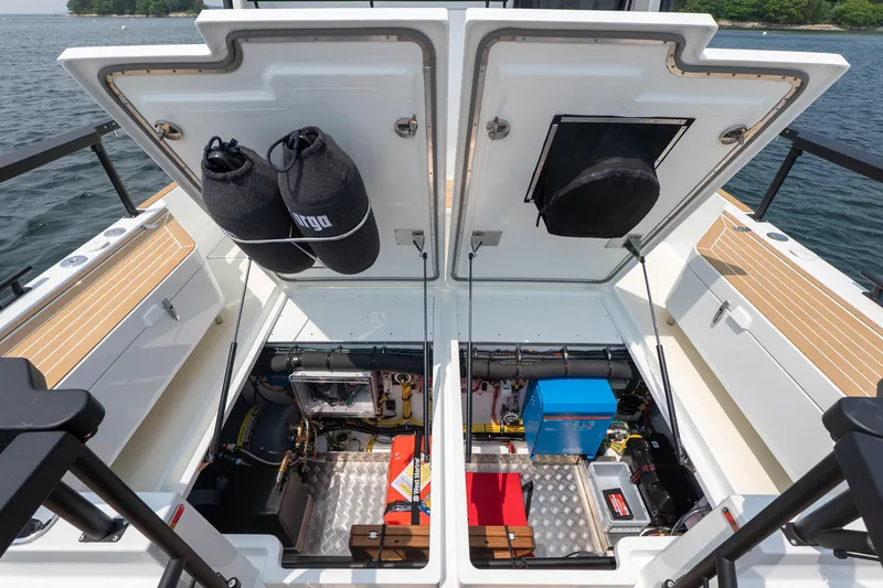 Slide: The Image of Open engine compartment of 2025 Targa 32 GT boat, showcasing storage and equipment. - 8