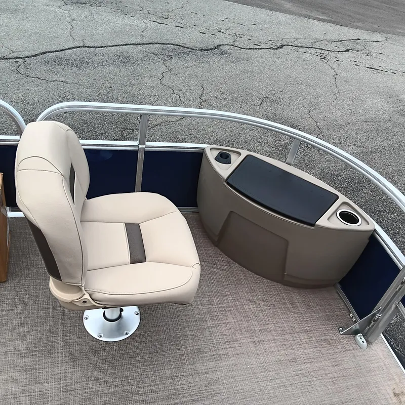 Slide: The Image of 2025 Sun Tracker Bass Buggy 18 DLX boat interior with beige seating and storage console. - 11
