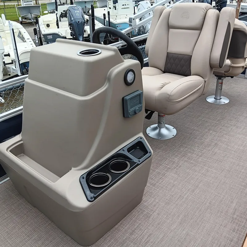 Slide: The Image of 2025 Sun Tracker Bass Buggy 18 DLX interior with beige captain's chair and console. - 12
