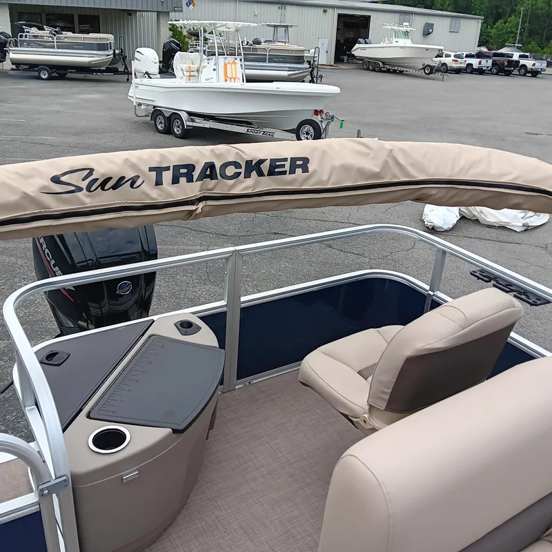 Slide: The Image of 2025 Sun Tracker Bass Buggy 18 DLX pontoon boat interior with seating and console. - 16
