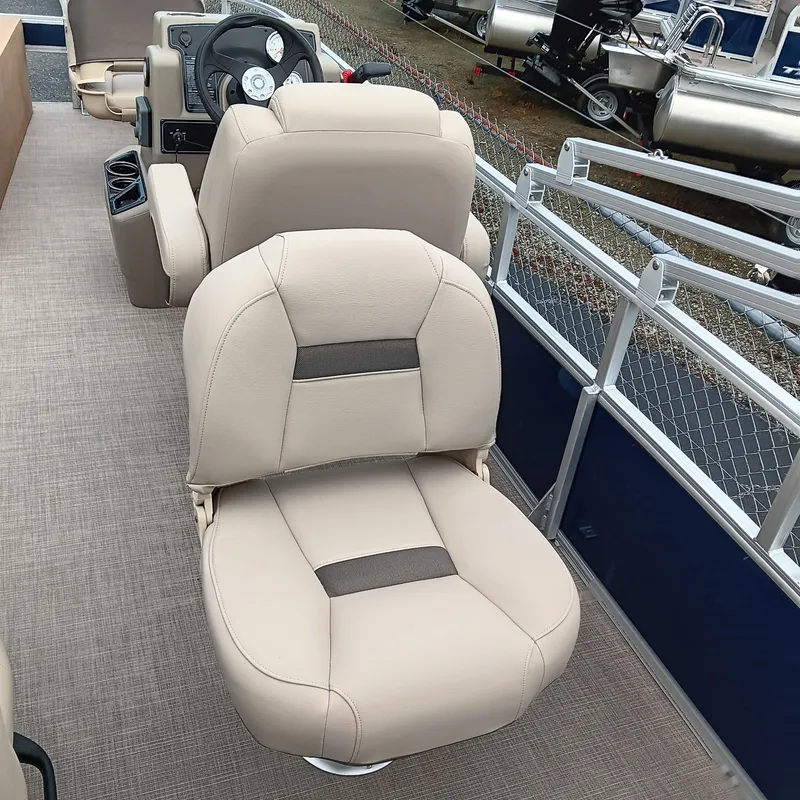 Slide: The Image of 2025 Sun Tracker Bass Buggy 18 DLX interior with beige seating and steering console. - 17