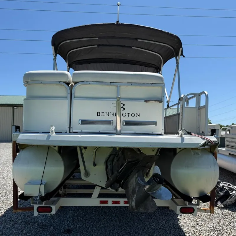 Slide: The Image of Rear view of a 2006 Bennington 2575 RFS - IO pontoon boat on gravel. - 11