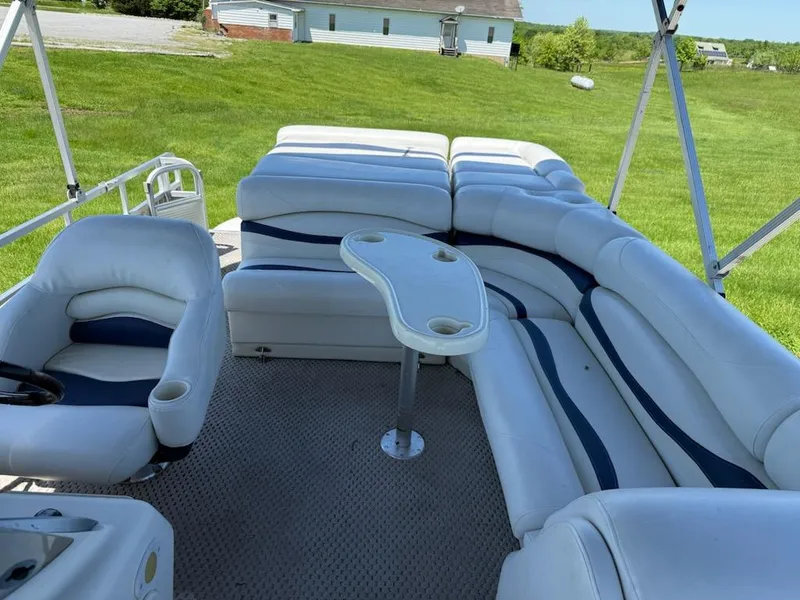 Slide: The Image of 2006 Bennington 2575 RFS - IO pontoon boat with white seating and a central table. - 14