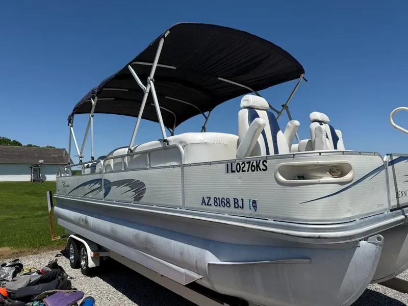 Slide: The Image of 2006 Bennington 2575 RFS - IO pontoon boat on trailer, with canopy, parked outdoors. - 3