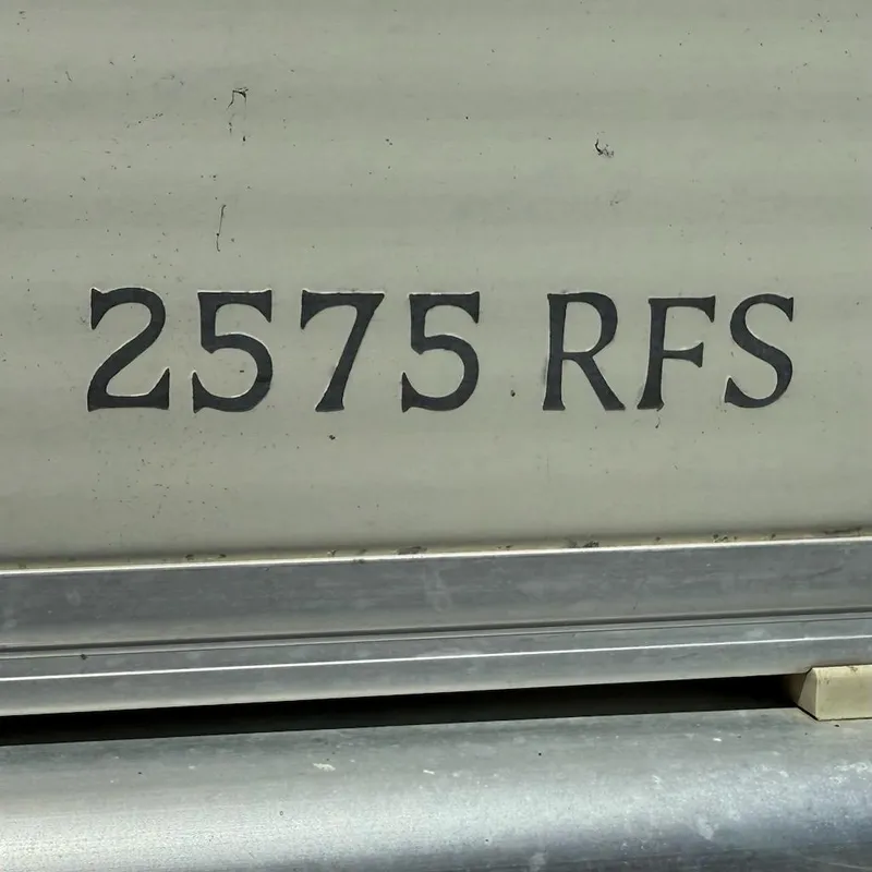 Slide: The Image of Close-up of 2006 Bennington 2575 RFS model name on boat exterior. - 4