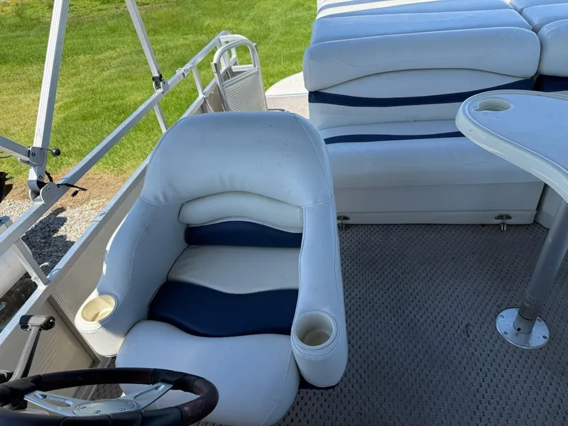 Slide: The Image of 2006 Bennington 2575 RFS - IO boat interior with white and blue seating. - 6