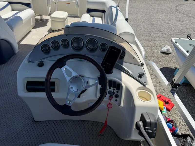 Slide: The Image of 2006 Bennington 2575 RFS - IO boat dashboard with steering wheel and gauges. - 7
