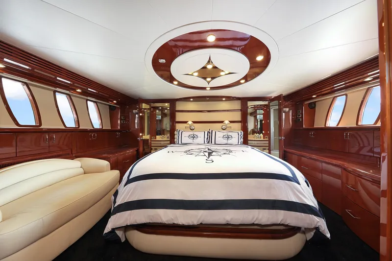 Slide: The Image of Luxurious 2007 Marquis 65 yacht bedroom with elegant wood finishes and plush bedding. - 10