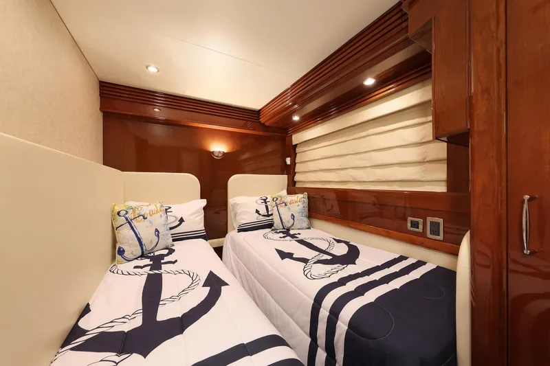 Slide: The Image of Luxurious twin cabin with nautical-themed bedding in a 2007 Marquis 65 yacht. - 18