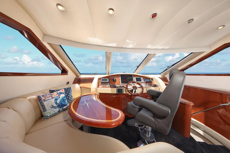 Slide: The Image of Luxurious 2007 Marquis 65 yacht interior with plush seating and modern helm. - 9