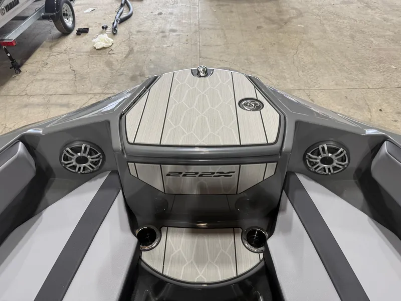 Slide: The Image of 2025 Yamaha Boats 222XD interior with sleek design, featuring speakers and cup holders. - 8