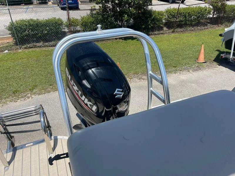 Slide: The Image of 2020 Silver Wave 2210 SW5 L boat with Suzuki outboard motor, docked on a sunny day. - 4