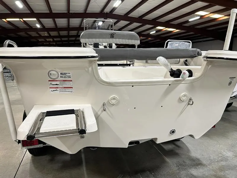 Slide: The Image of 2025 Carolina Skiff 21 LS boat, rear view in a warehouse setting. - 1