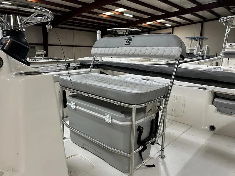 Slide: The Image of 2025 Carolina Skiff 21 LS boat interior with cushioned seating and storage cooler. - 5
