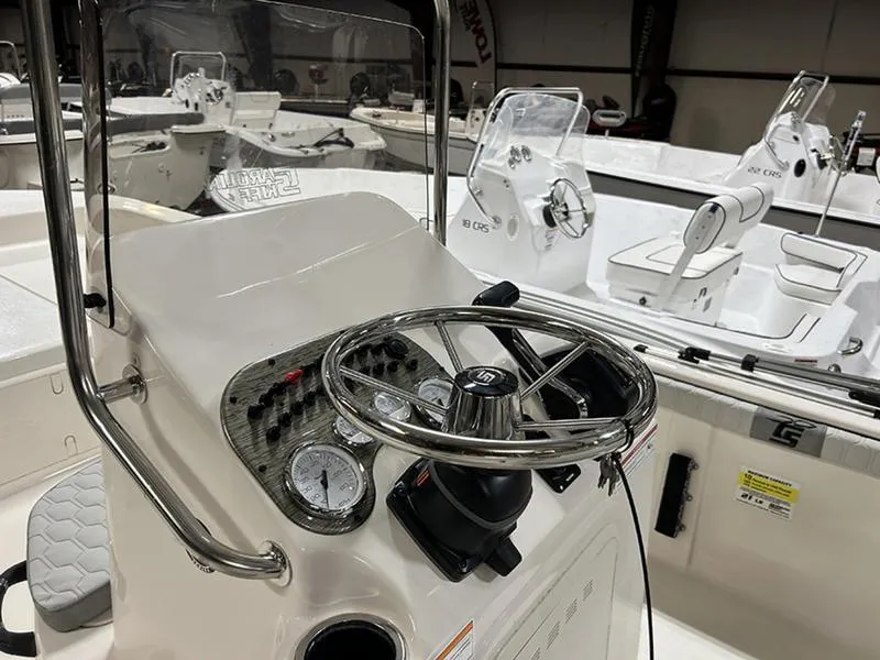 Slide: The Image of 2025 Carolina Skiff 21 LS boat dashboard with steering wheel and gauges. - 7