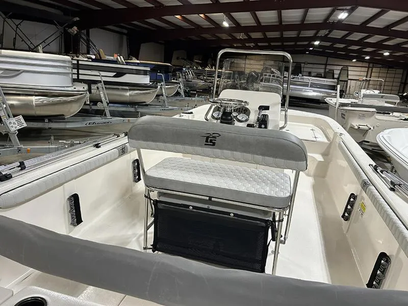 Slide: The Image of 2025 Carolina Skiff 21 LS boat interior in showroom, featuring seating and console. - 9