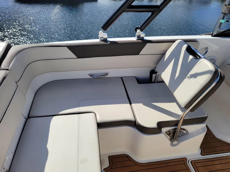 Slide: The Image of 2019 Bayliner VR6 Bowrider I/O interior with white seating and water view. - 10