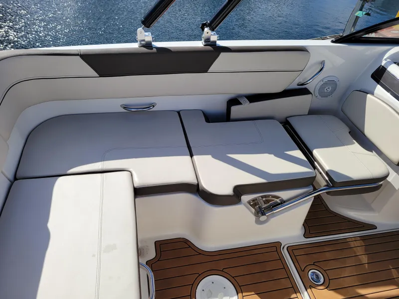 Slide: The Image of 2019 Bayliner VR6 Bowrider I/O interior with cushioned seating and wooden deck. - 11