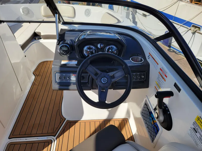 Slide: The Image of 2019 Bayliner VR6 Bowrider I/O cockpit with steering wheel and dashboard controls. - 15