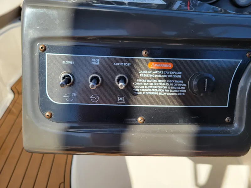 Slide: The Image of Control panel of a 2019 Bayliner VR6 Bowrider I/O with switches and warning label. - 18