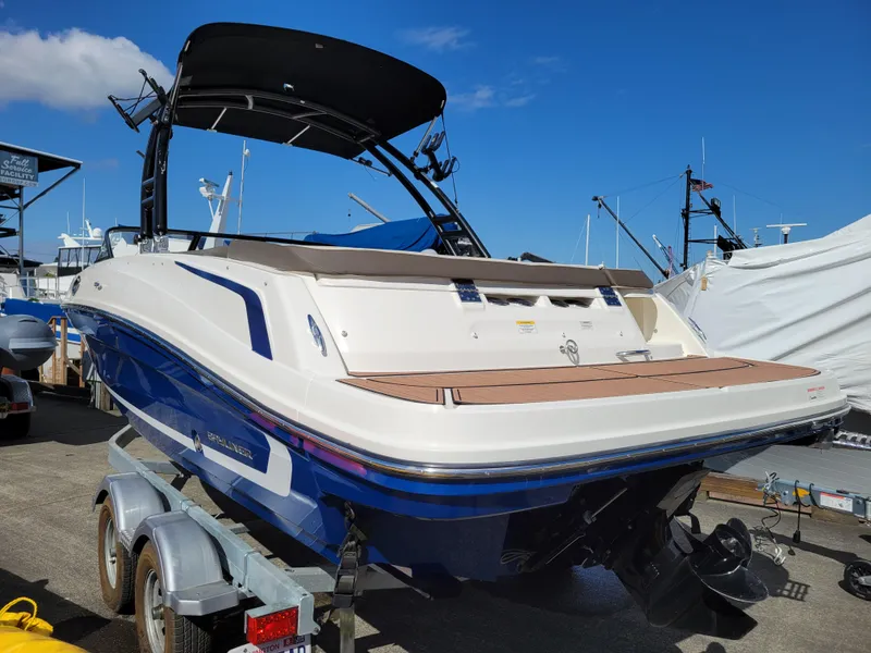 Slide: The Image of 2019 Bayliner VR6 Bowrider I/O boat on trailer, docked at marina. - 2