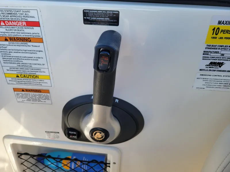 Slide: The Image of Throttle control and warning labels on a 2019 Bayliner VR6 Bowrider I/O boat. - 20