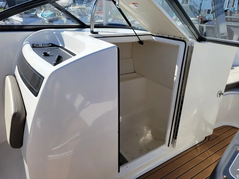 Slide: The Image of 2019 Bayliner VR6 Bowrider I/O interior cabin with open door, showcasing sleek design. - 22