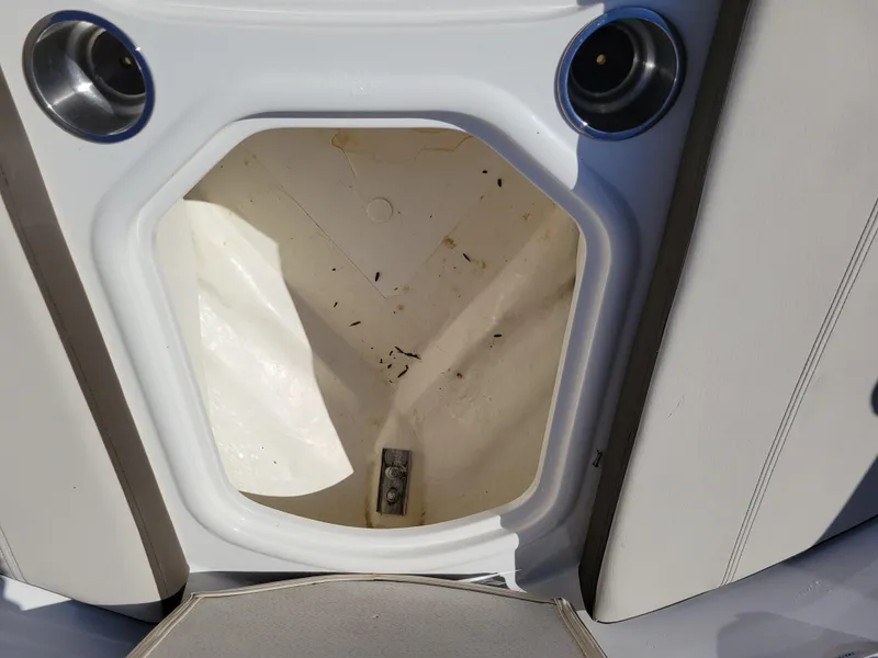 Slide: The Image of 2019 Bayliner VR6 Bowrider I/O storage compartment, open and empty, with cup holders visible. - 26