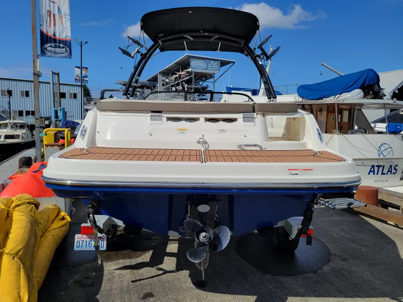Slide: The Image of 2019 Bayliner VR6 Bowrider I/O boat docked, rear view with propeller and swim platform. - 3