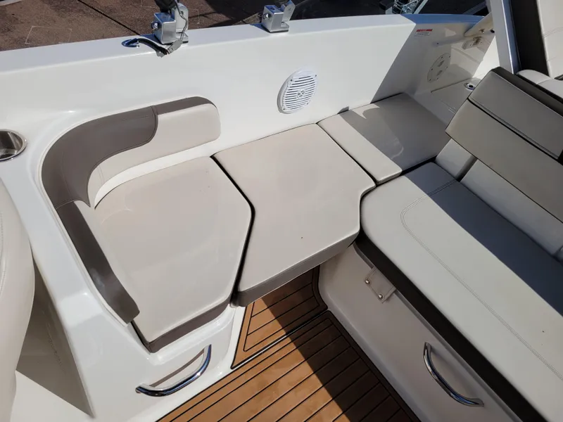 Slide: The Image of 2019 Bayliner VR6 Bowrider I/O interior seating with beige cushions and wood flooring. - 30