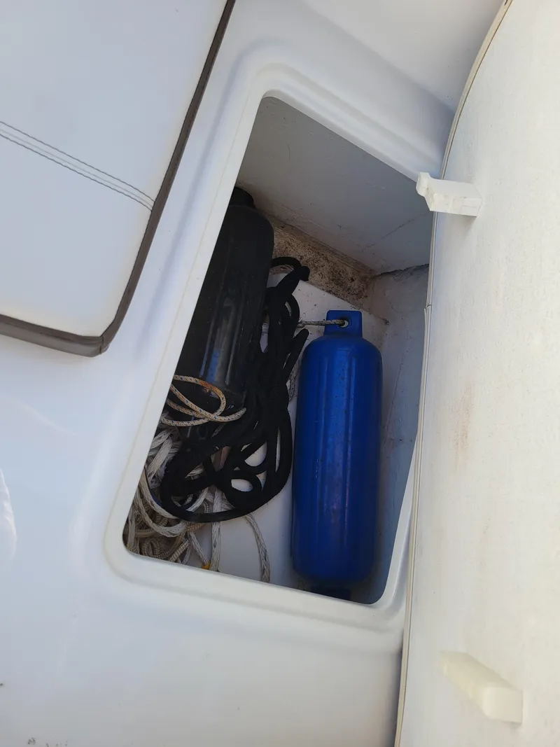 Slide: The Image of Storage compartment in a 2019 Bayliner VR6 Bowrider I/O with ropes and a blue fender. - 33