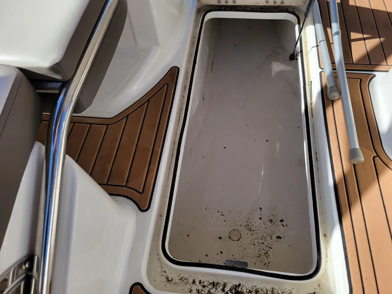 Slide: The Image of 2019 Bayliner VR6 Bowrider I/O storage compartment with teak flooring and stainless steel railing. - 36