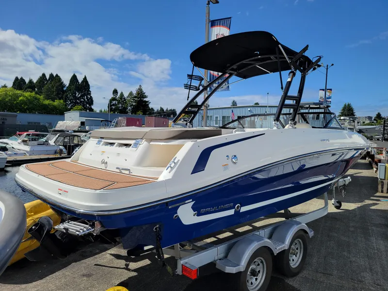 Slide: The Image of 2019 Bayliner VR6 Bowrider I/O on trailer, blue and white, sunny day, outdoor display. - 4