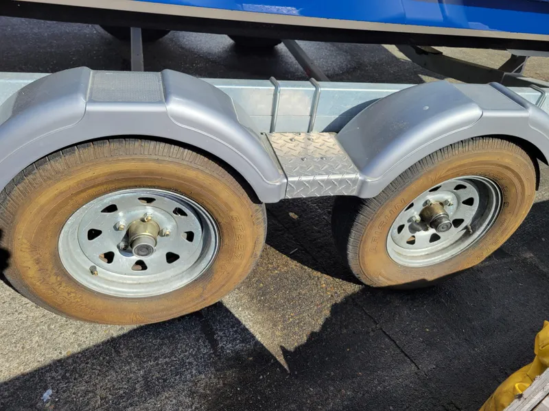 Slide: The Image of Trailer wheels of a 2019 Bayliner VR6 Bowrider I/O boat on pavement. - 43