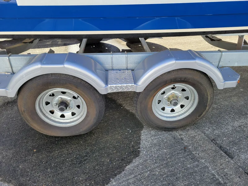 Slide: The Image of Trailer wheels of a 2019 Bayliner VR6 Bowrider I/O boat on pavement. - 44