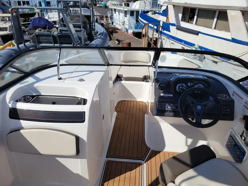 Slide: The Image of 2019 Bayliner VR6 Bowrider I/O interior with wood flooring and modern dashboard. - 8