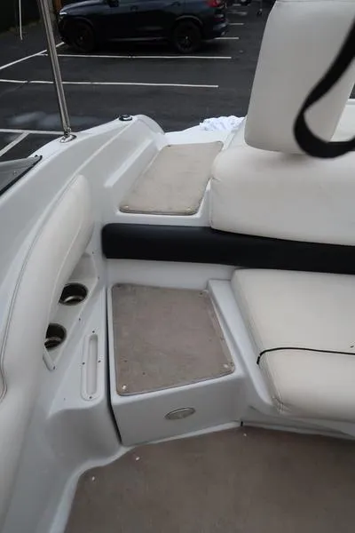 Slide: The Image of 2008 Crownline 21LS boat interior with white seating and carpeted steps. - 10